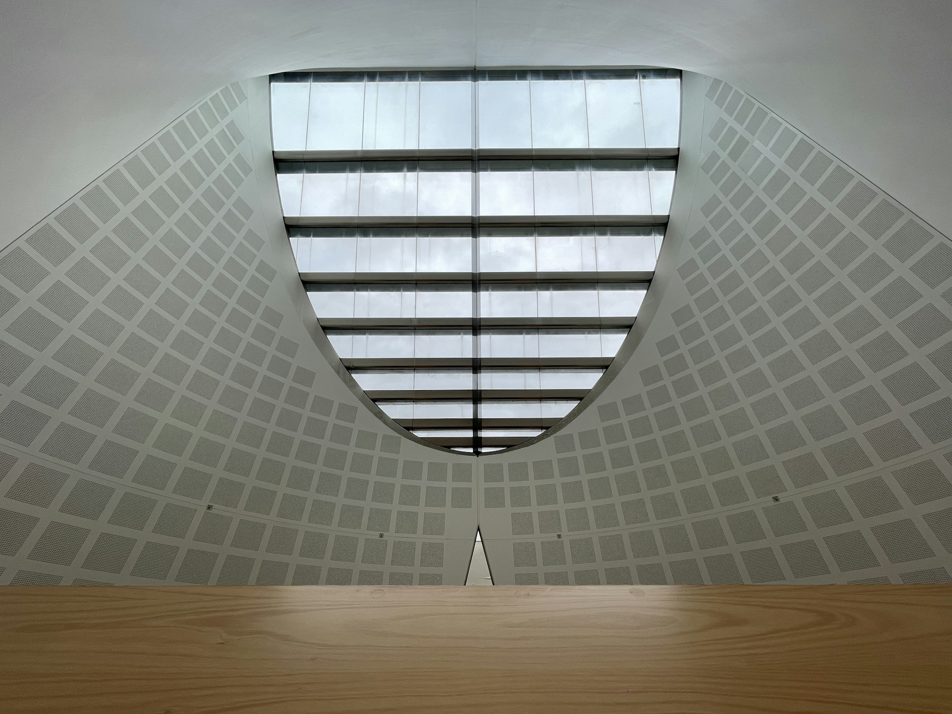 a room with a wooden table and a skylight