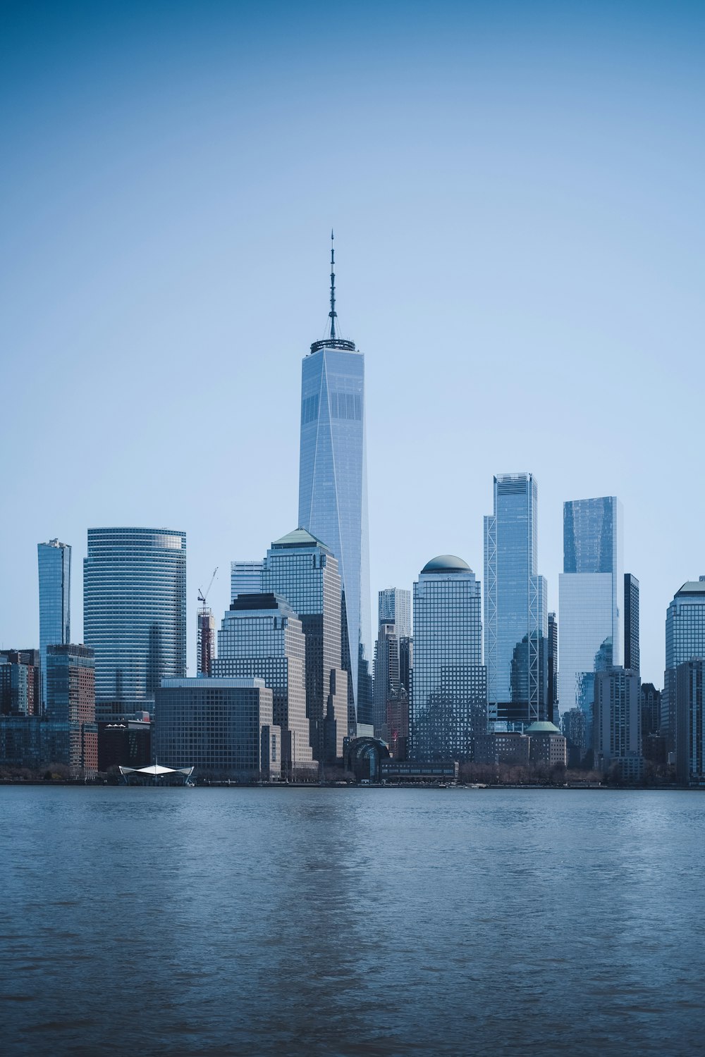 city skyline across body of water during daytime