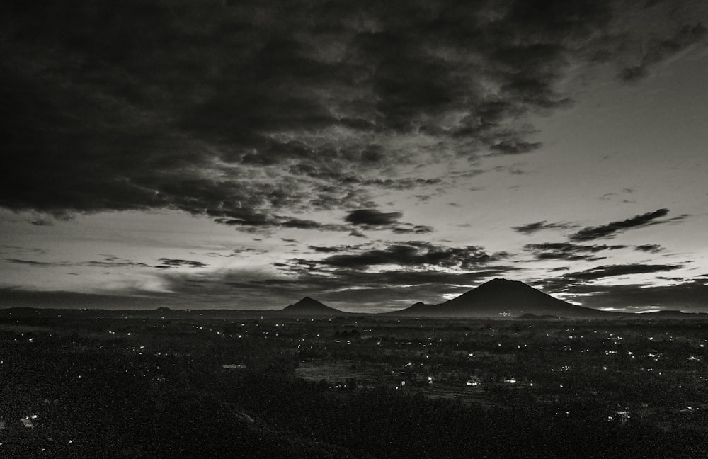 silhouette of mountains under cloudy sky during daytime