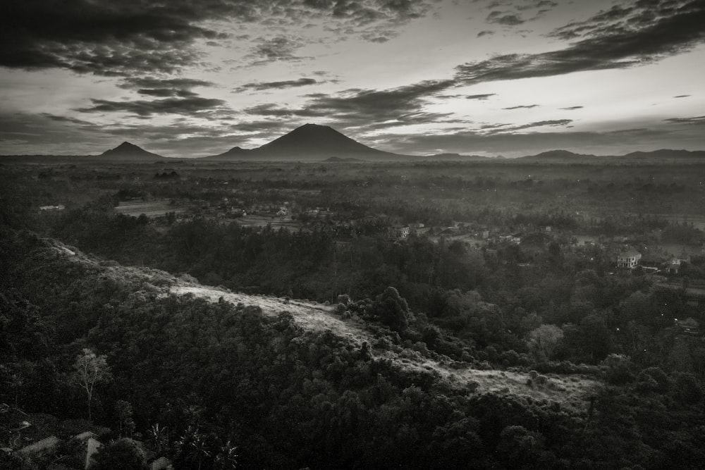 grayscale photo of mountains and clouds