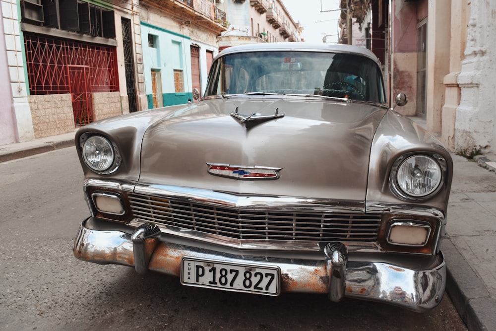 silver car parked beside brown concrete building during daytime