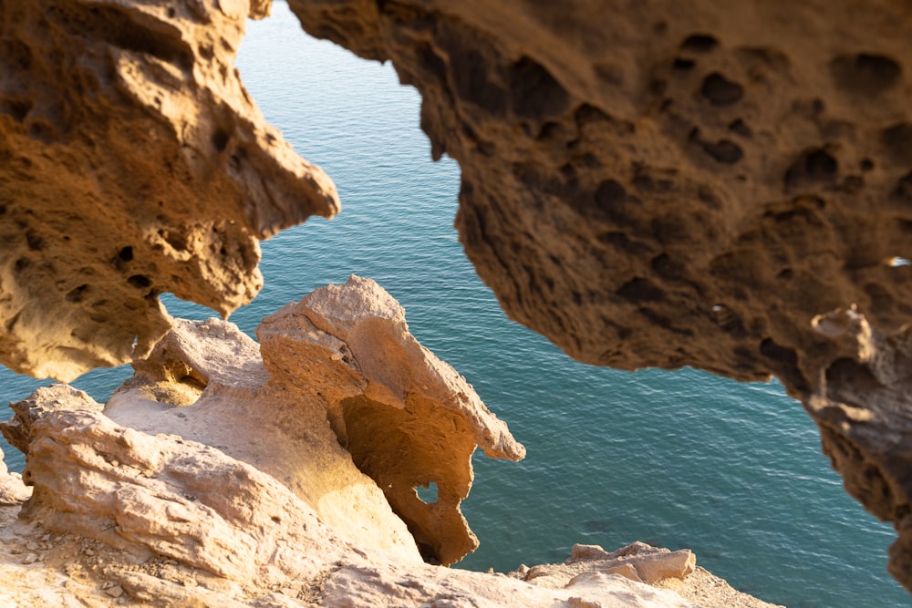 brown rock formation near blue sea during daytime