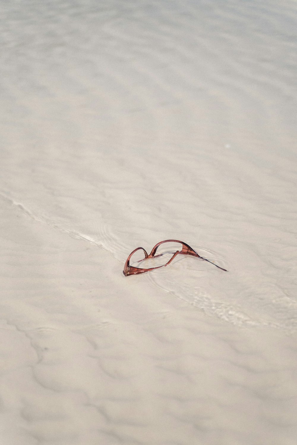 red and black rope on white sand