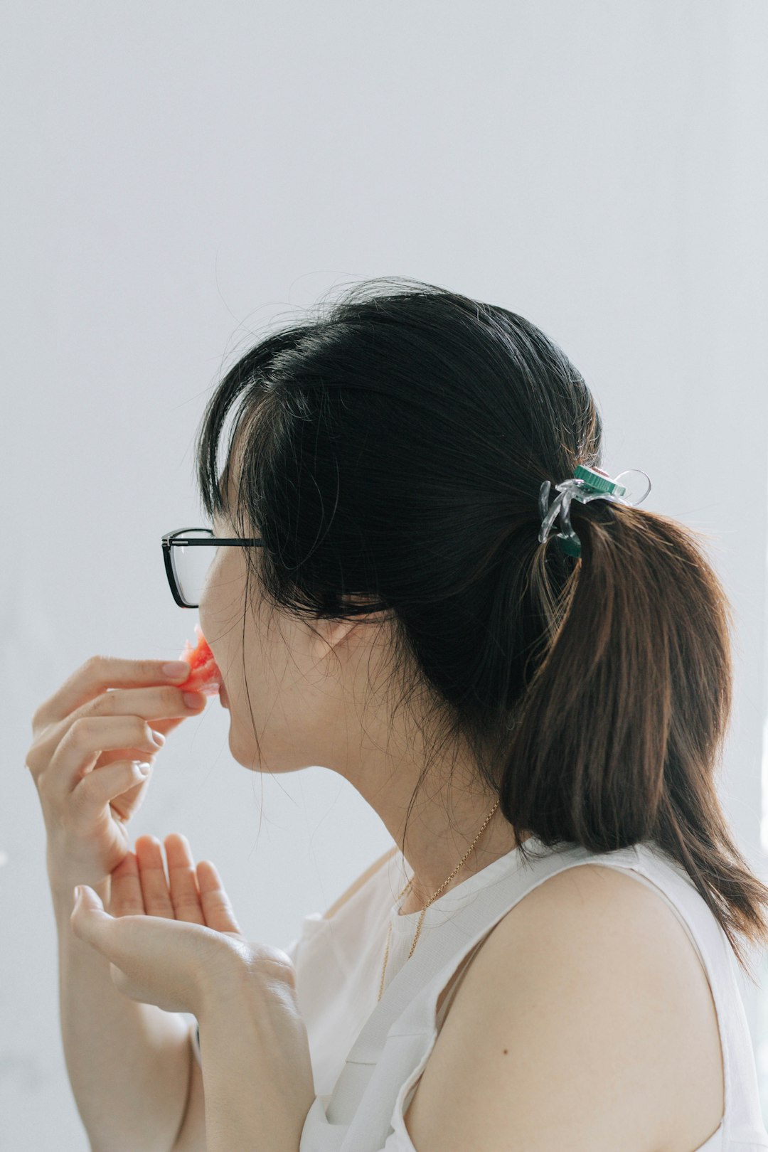 woman in white tank top wearing eyeglasses