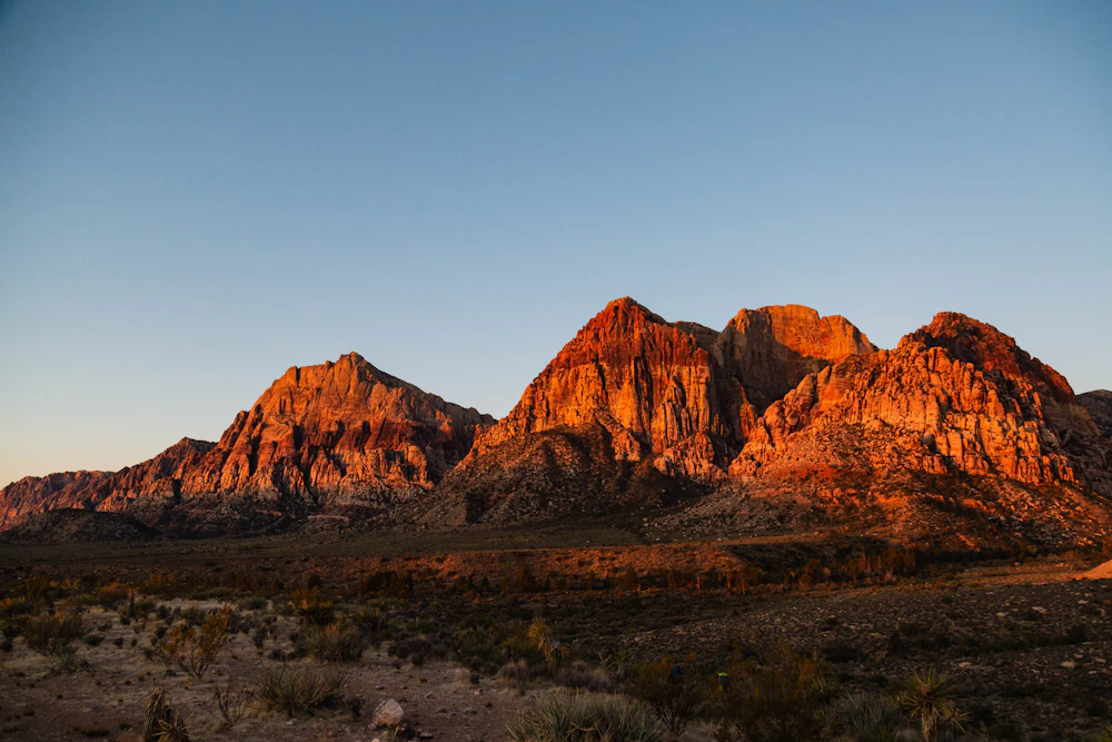 Red sandstone peaks glowing at sunset above the desert