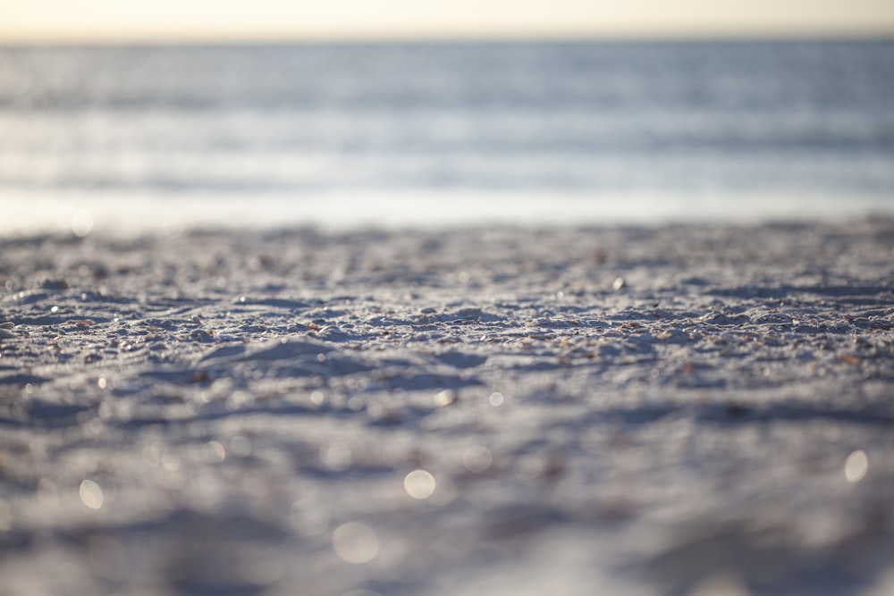 water droplets on gray sand during daytime