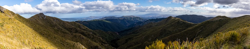 green mountains under white clouds during daytime