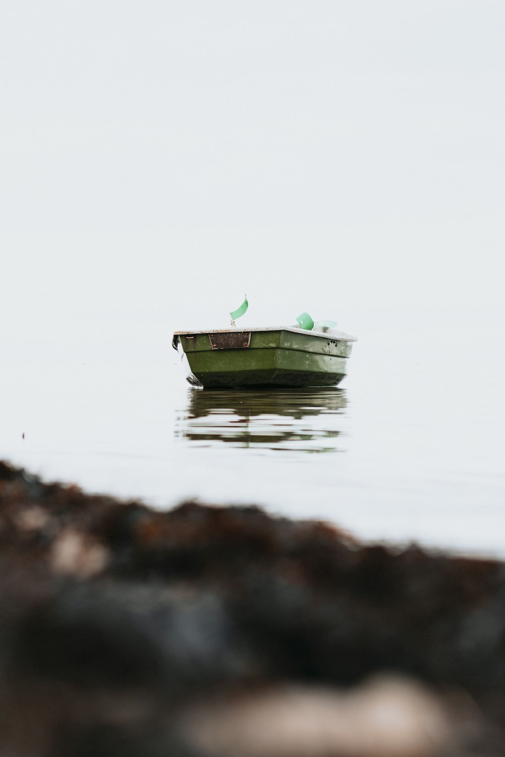 green and white boat on water