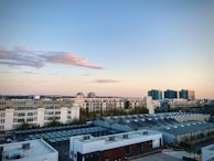 Modern city apartment with skyline views at sunset.