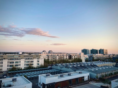 Modern downtown apartment with city skyline views at sunset.