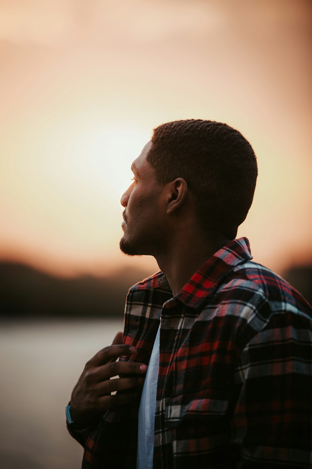 man in red white and blue plaid dress shirt