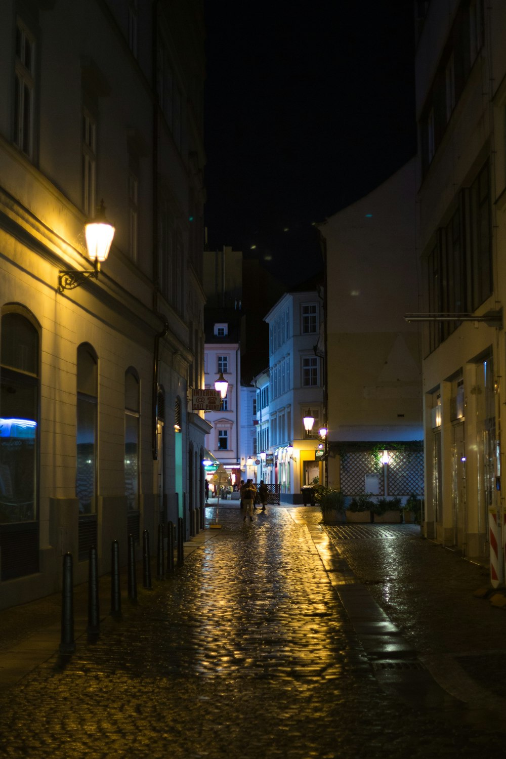 people walking on sidewalk during night time