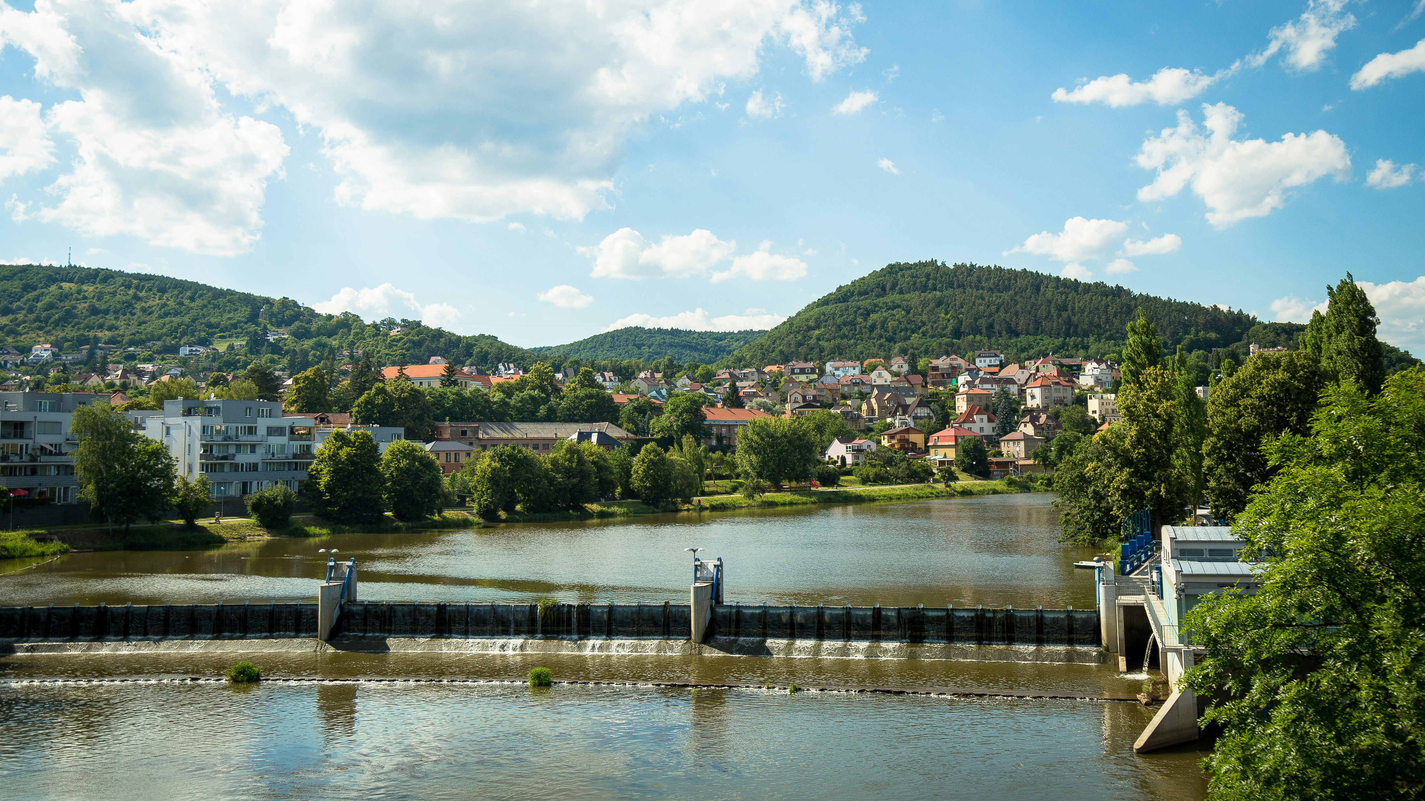 people walking on concrete bridge over river during daytime