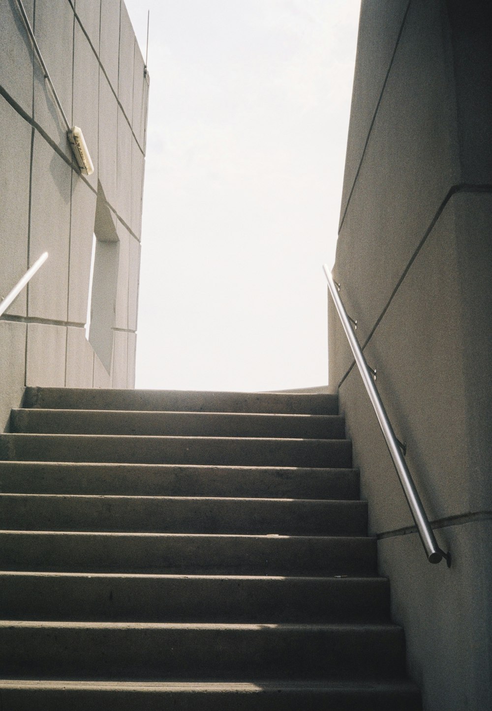 black and white staircase with stainless steel railings