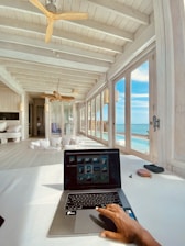 A property owner reviewing booking details on a laptop in a cozy home office.