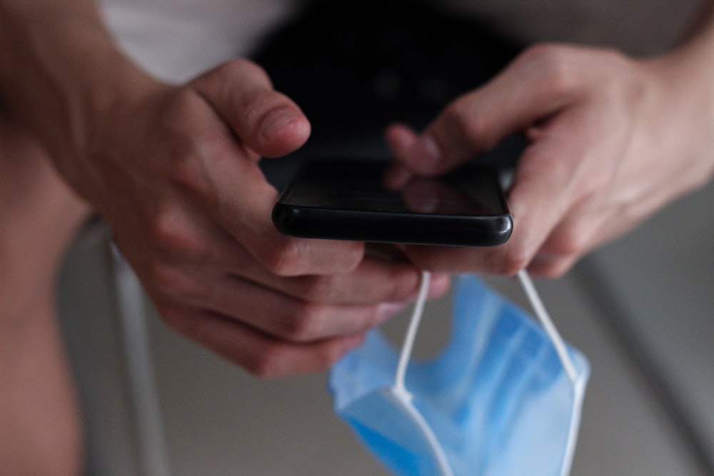 person holding black android smartphone