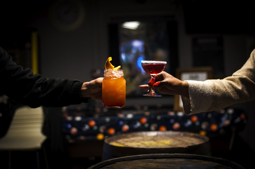 a couple of people that are holding some drinks