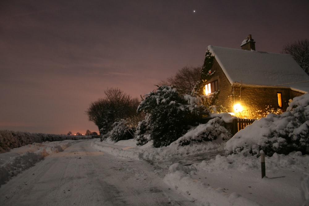 a house is covered in snow at night