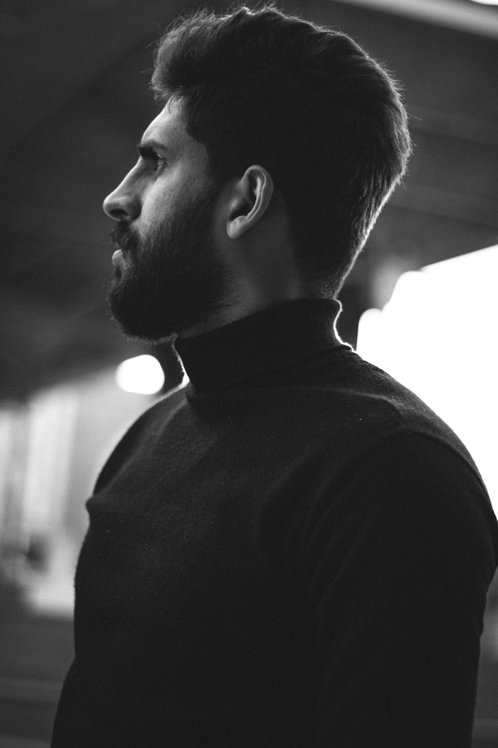 a black and white photo of a man with a beard