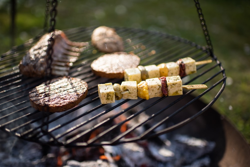 a bbq grill with meat and vegetables cooking on it