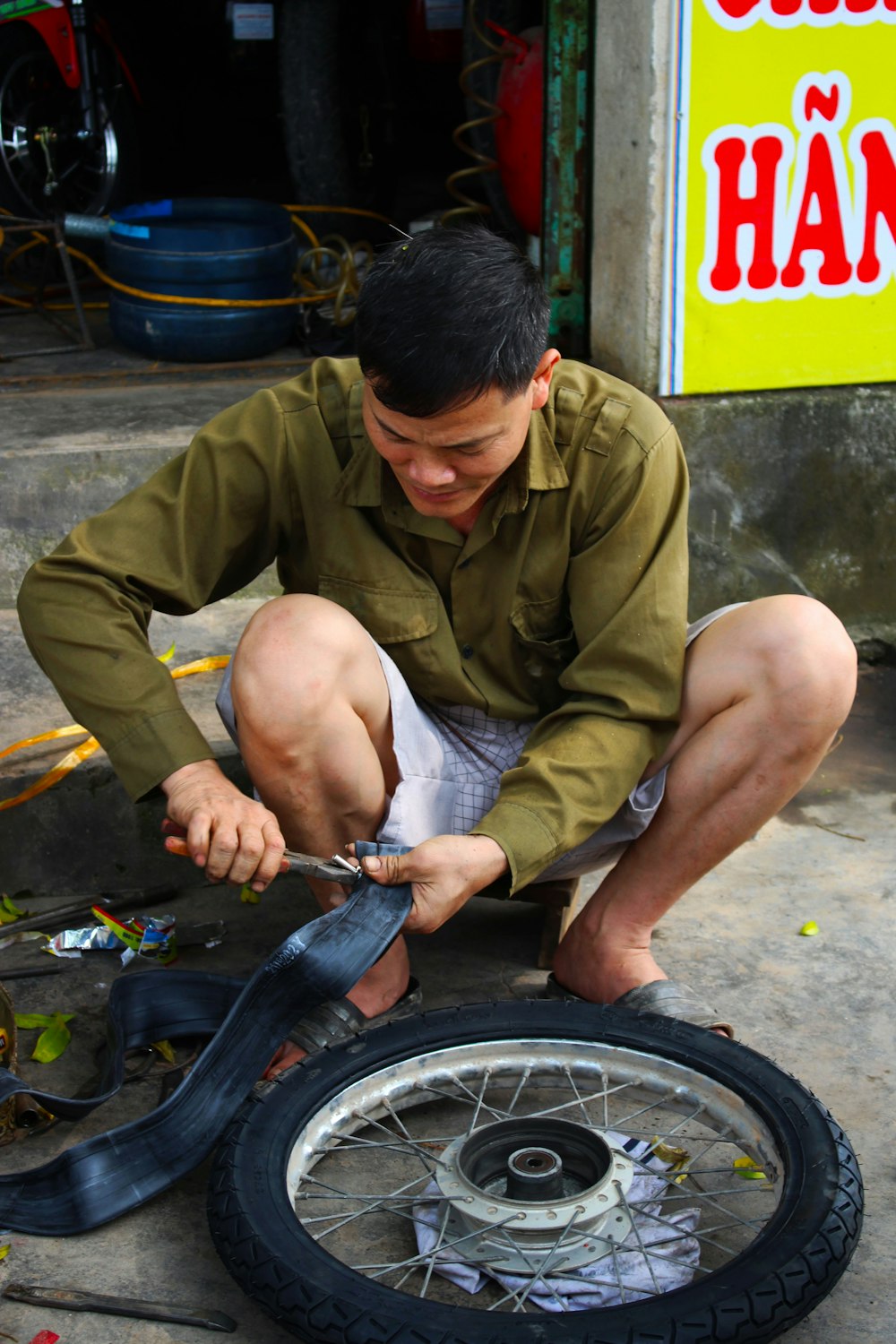 man in brown button up shirt sitting on bicycle