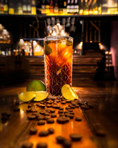 clear drinking glass with orange liquid on brown wooden table