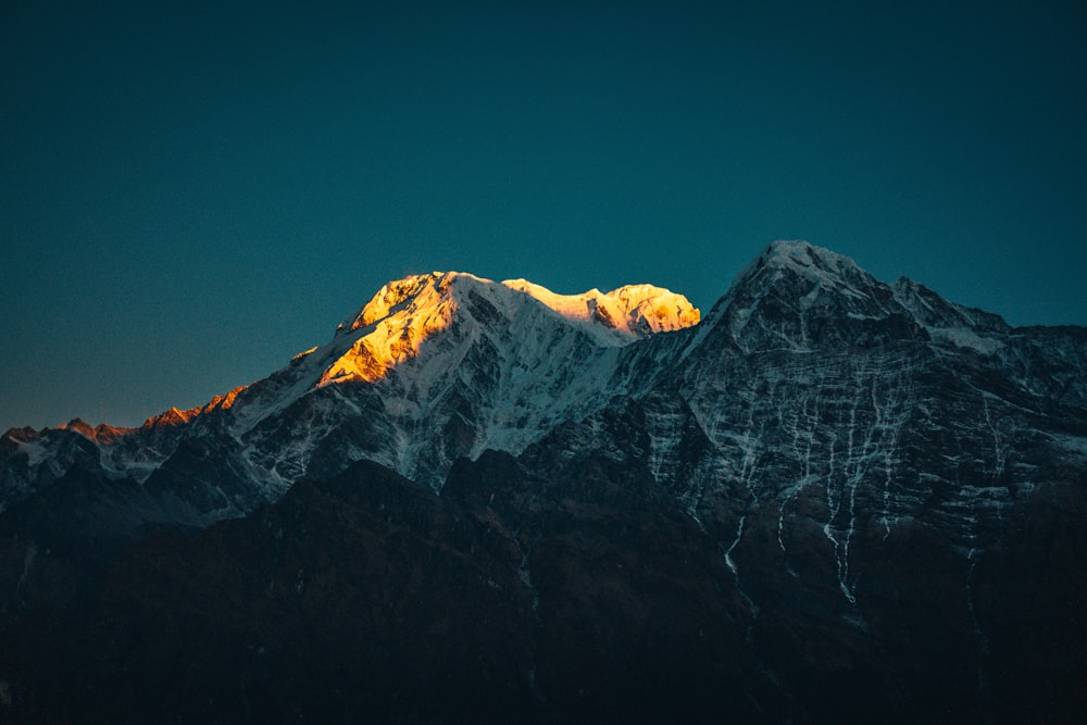 snow covered mountain under blue sky during daytime