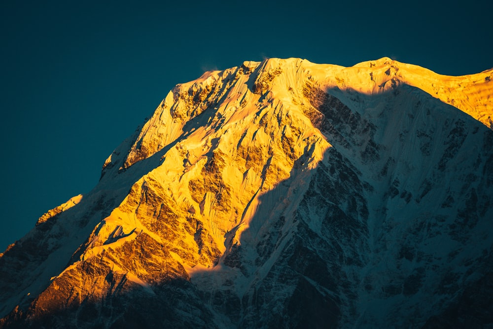 snow covered mountain under blue sky during daytime