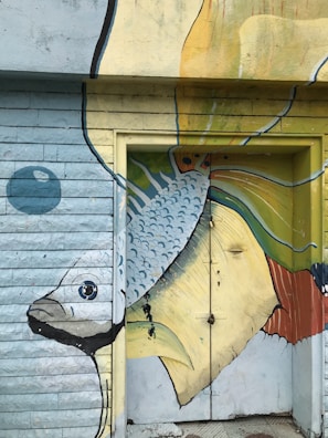 A vibrant mural of a fish swimming through swirling colors symbolizing imagination in motion.