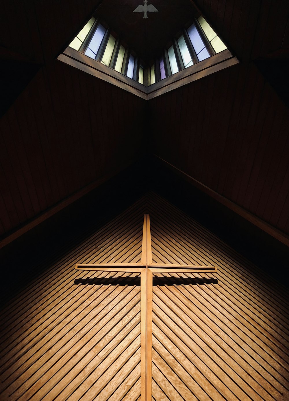 brown wooden cross on brown wooden ceiling