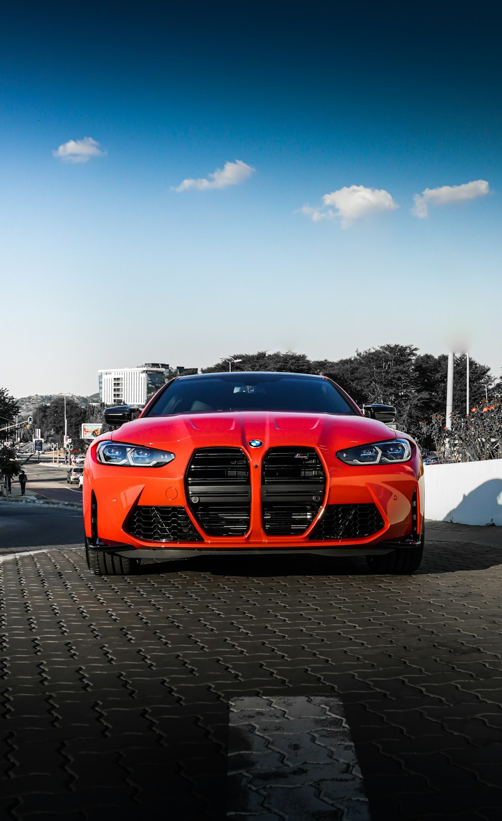 orange bmw car on road during daytime