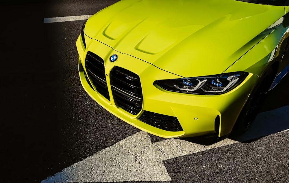 yellow mercedes benz car on gray asphalt road