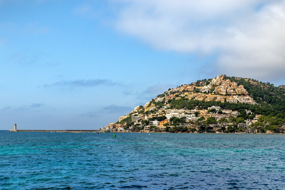 green and brown rock formation on sea under blue sky during daytime