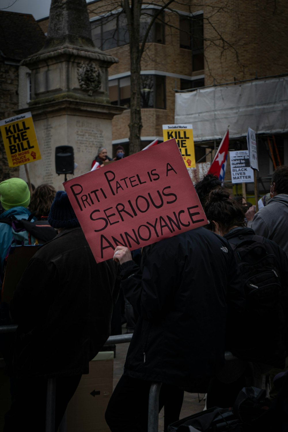 people holding blue and black printed banner