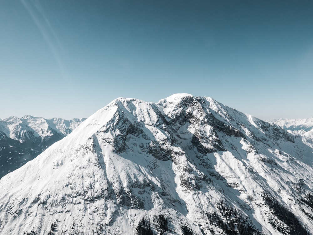 snow covered mountain under blue sky during daytime