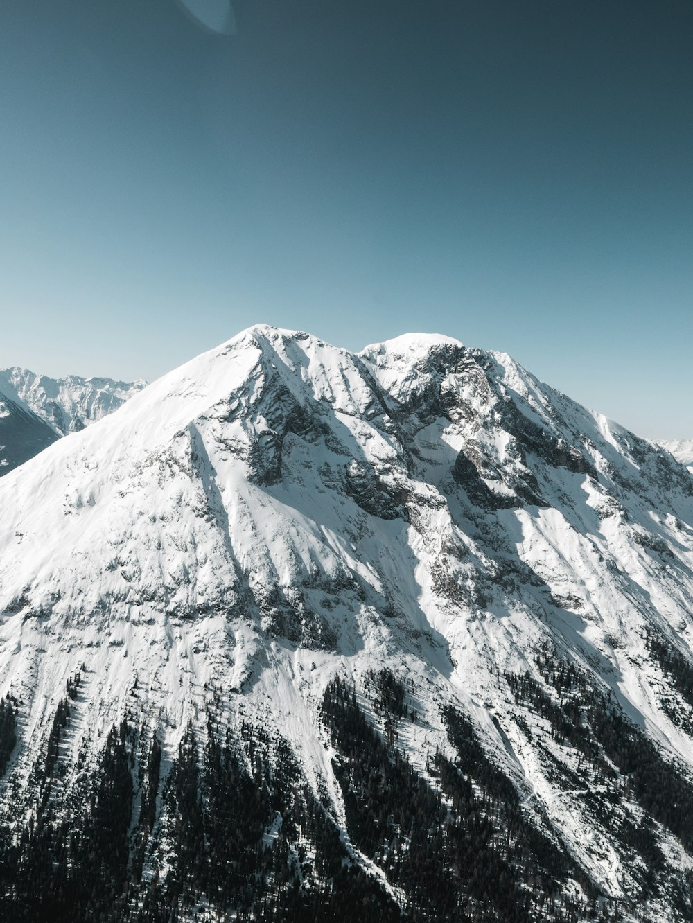 snow covered mountain under blue sky during daytime