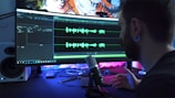 man in front of computer monitor