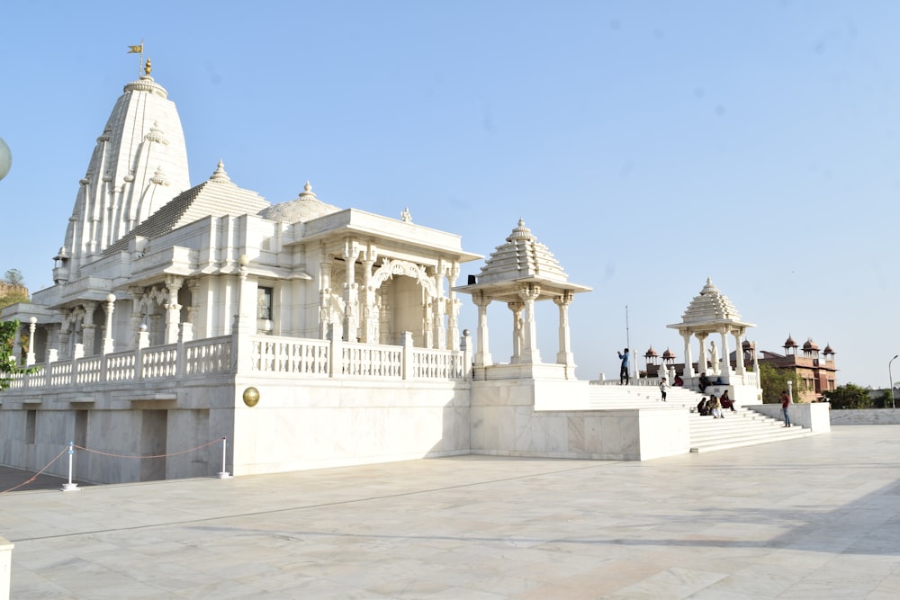 people walking on white concrete building during daytime