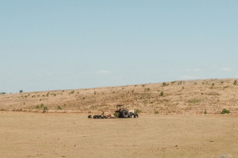 black and white car on brown field during daytime