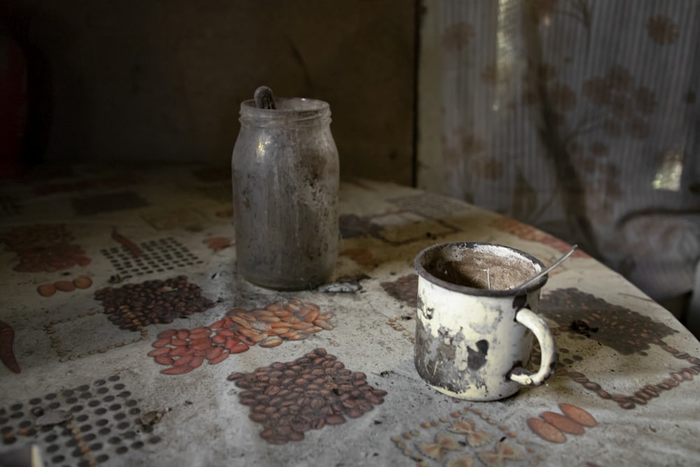 white ceramic mug on white and red table cloth