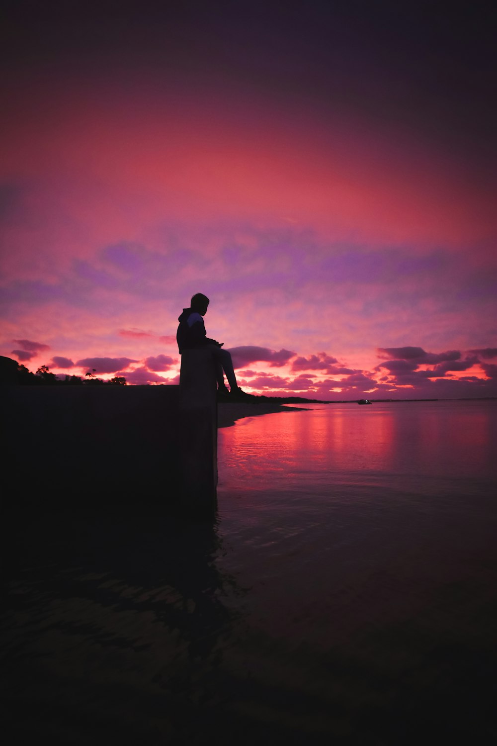 silhouette of man and woman kissing on beach during sunset