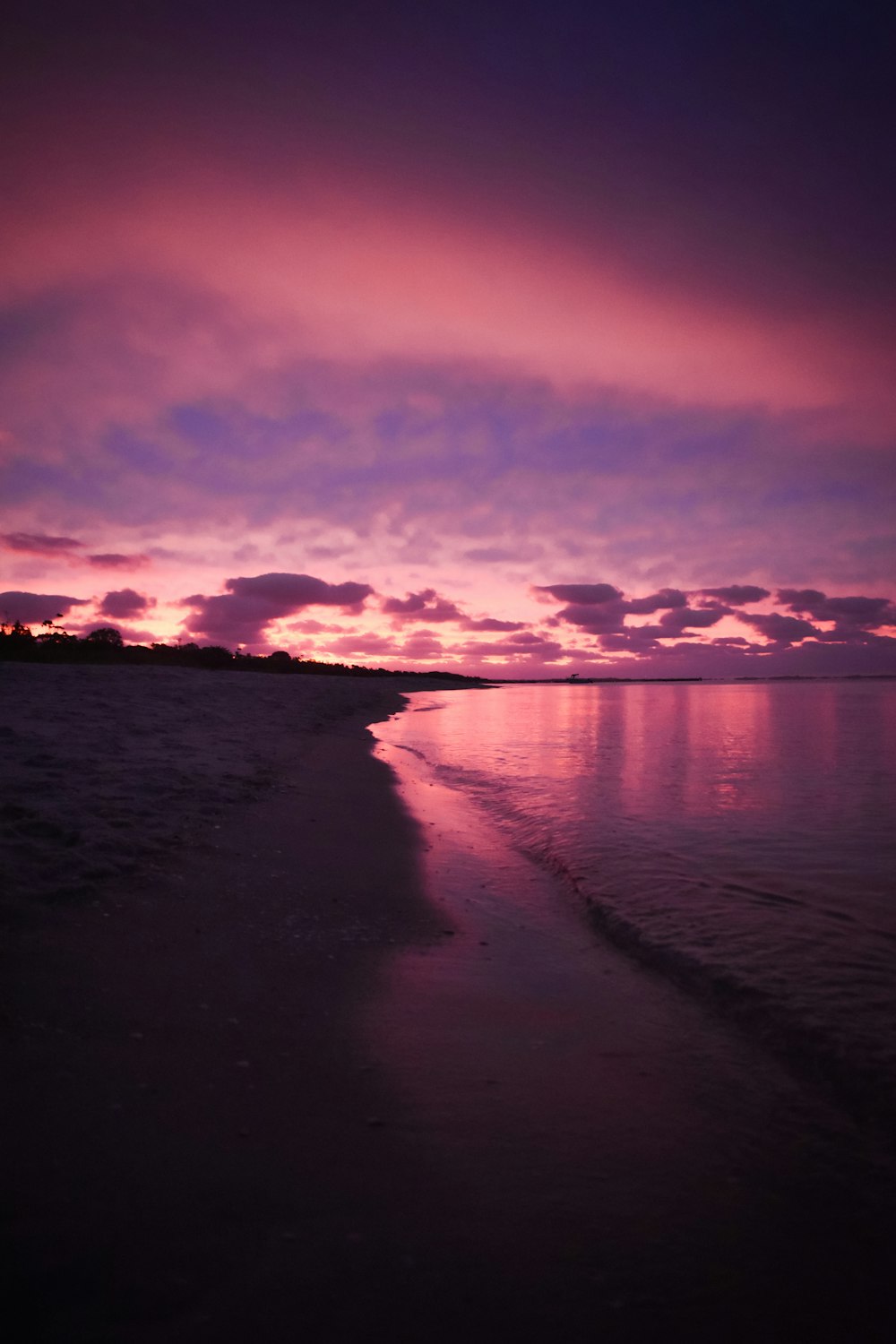 body of water under cloudy sky during sunset