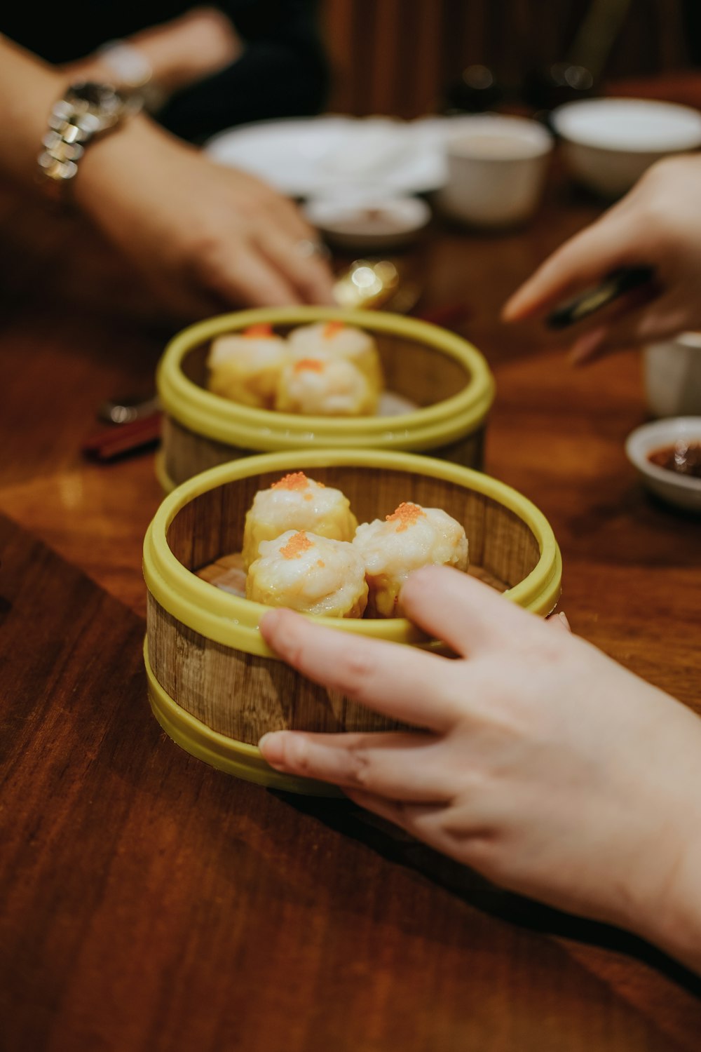 person holding green plastic bowl with food