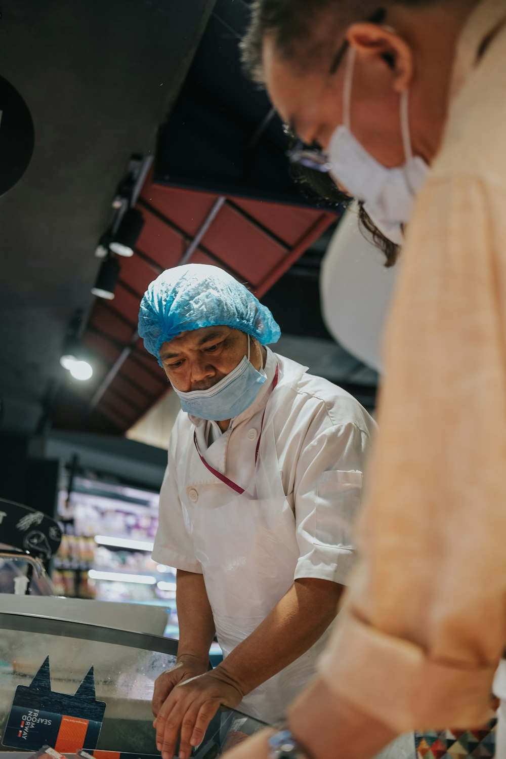 man in white chef uniform wearing blue and white face mask