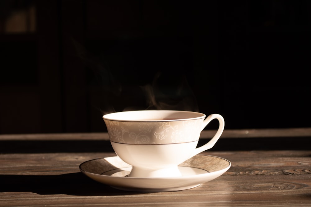 white ceramic teacup on saucer