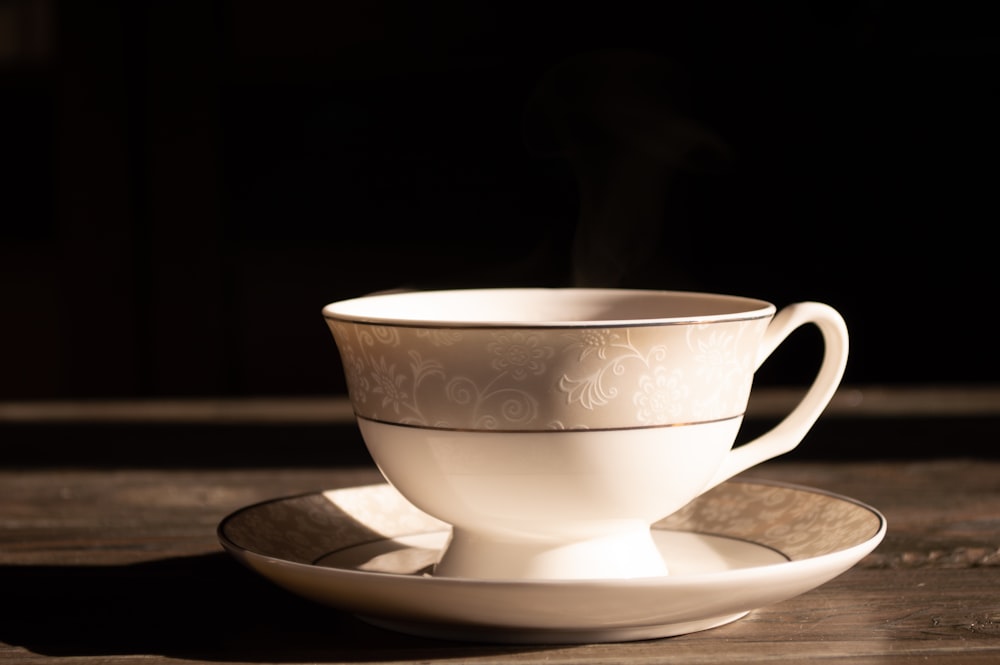 white ceramic teacup on saucer