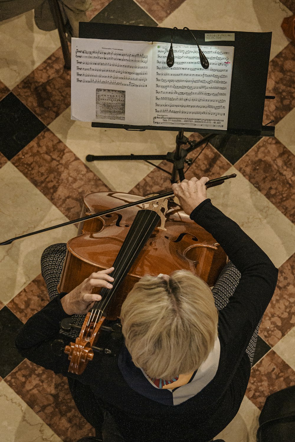 person playing violin on brown floor