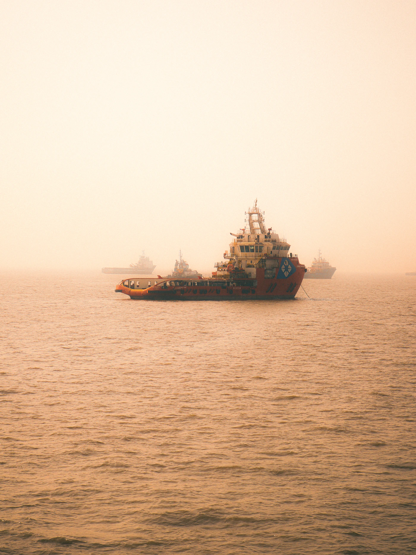 Working cargo ship under an open sky at sea, representing seamen covered by the Jones Act