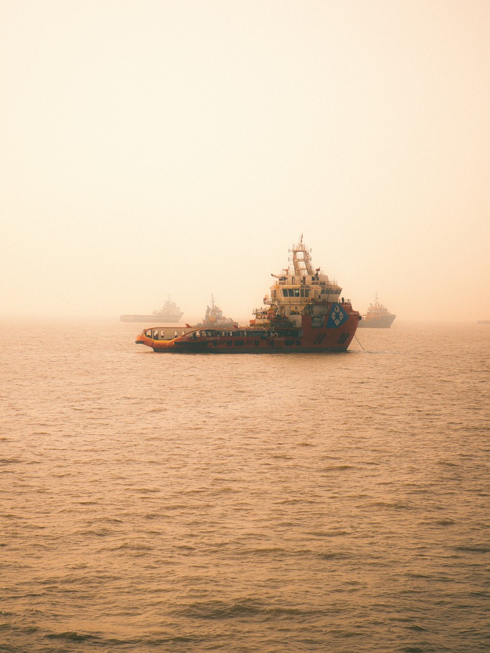 black and brown ship on sea under white sky during daytime