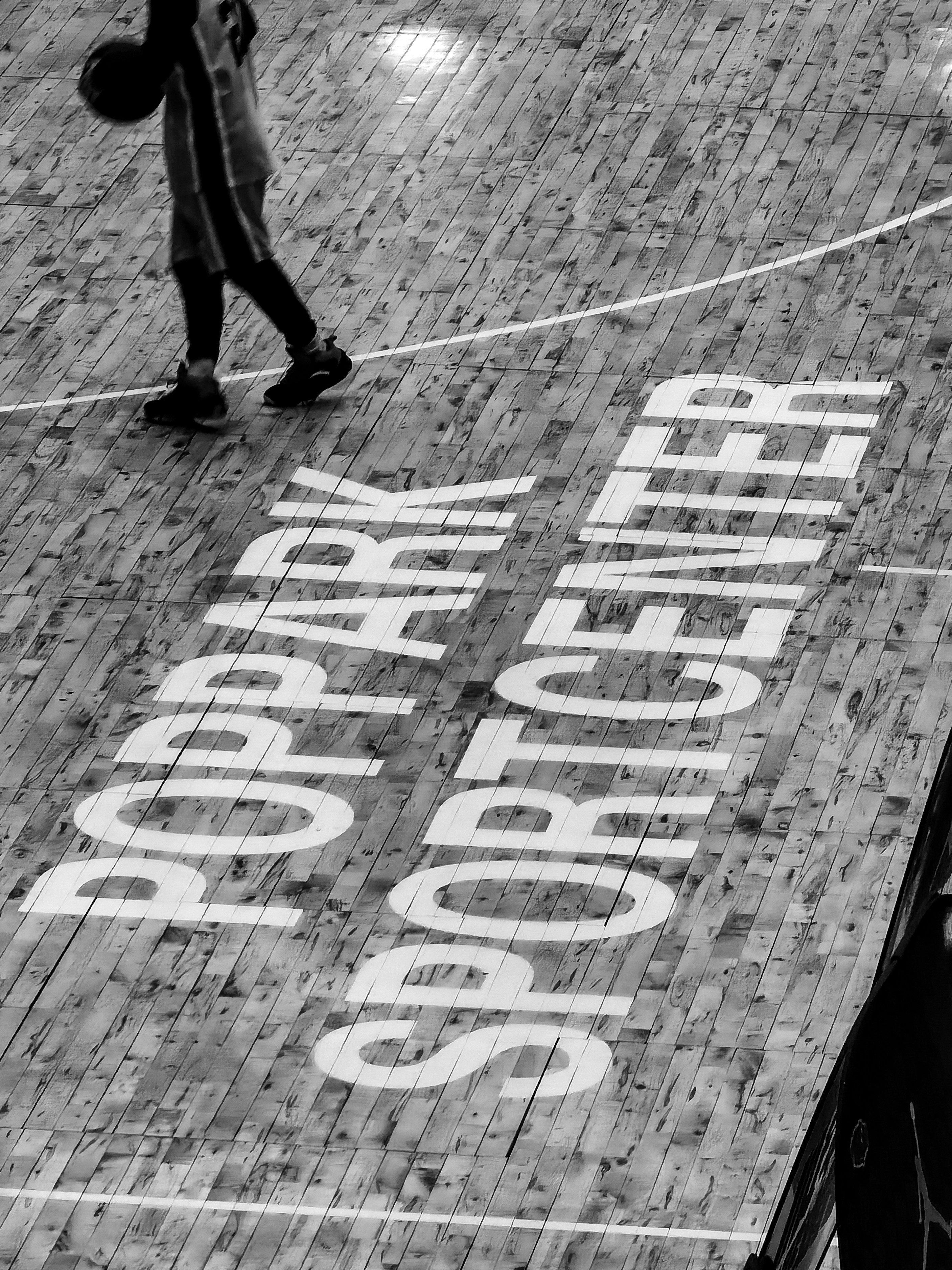 person in black pants walking on street